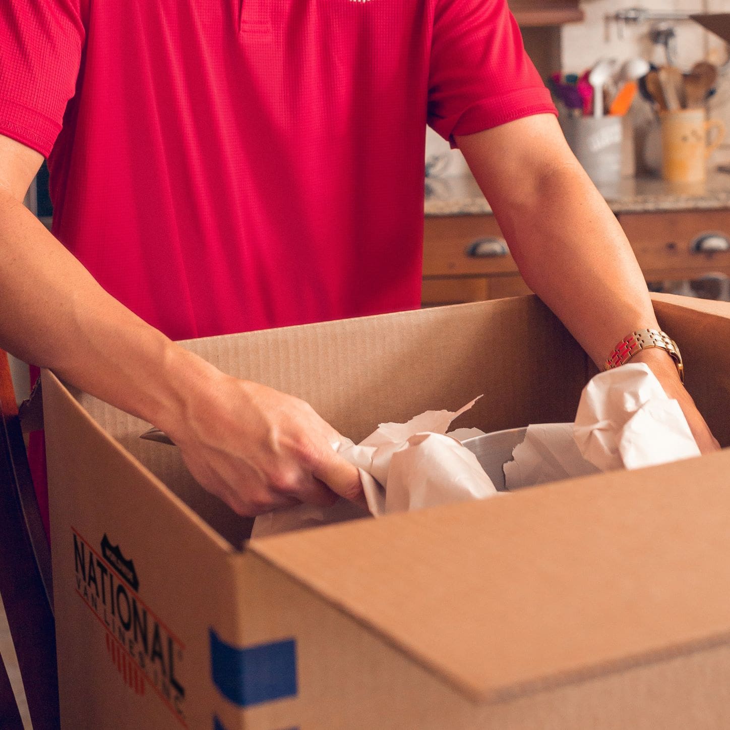 Mighty Moving staff packing items into a box