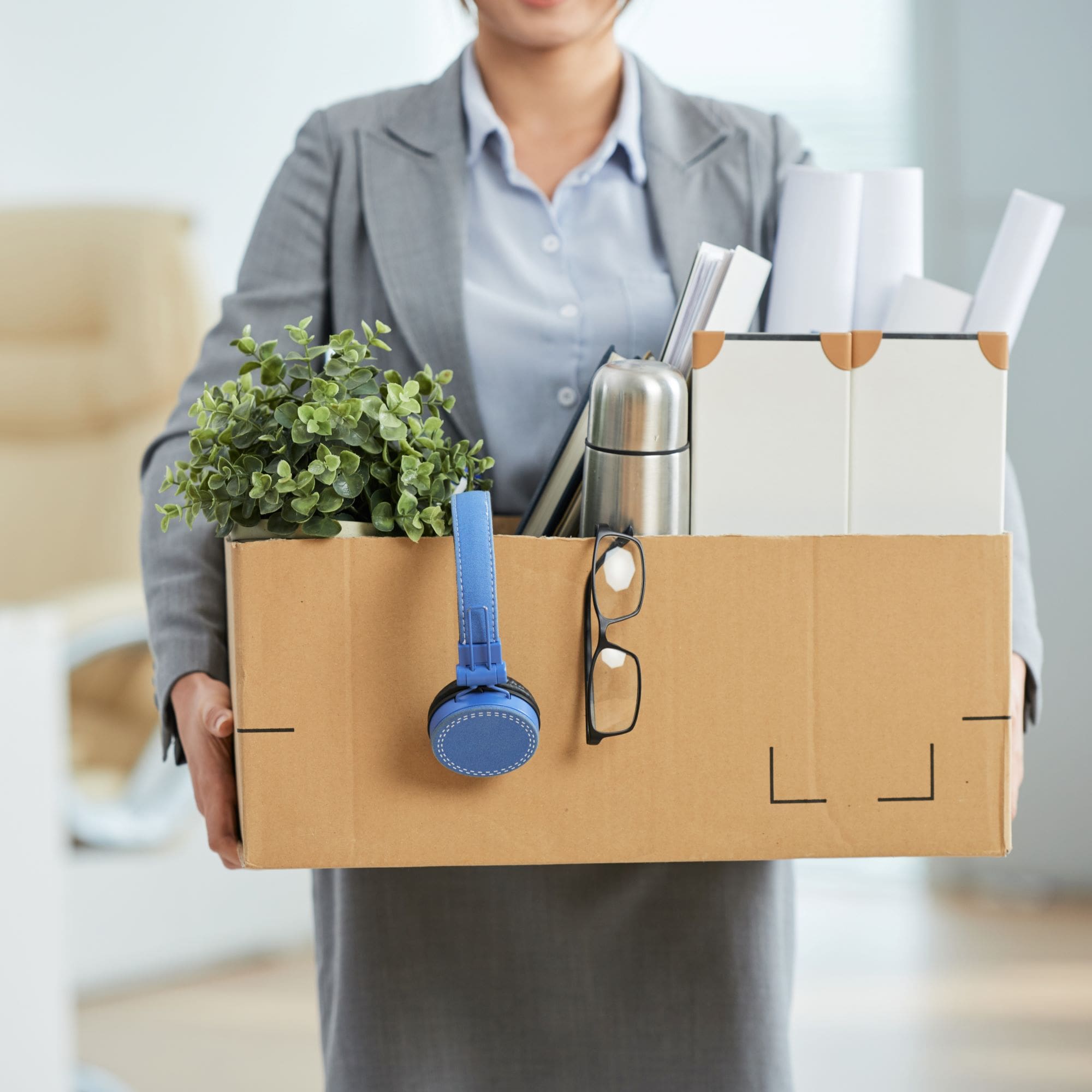 A businesswoman carrying a box to move into a new office